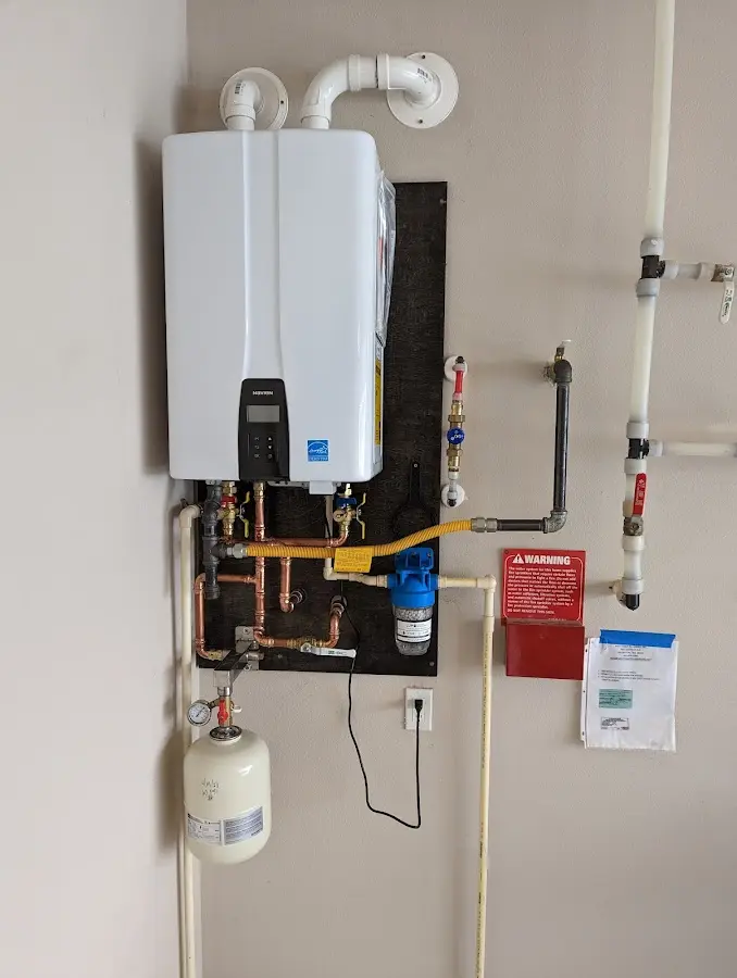 Professional plumber installing copper piping in a Goldstream home